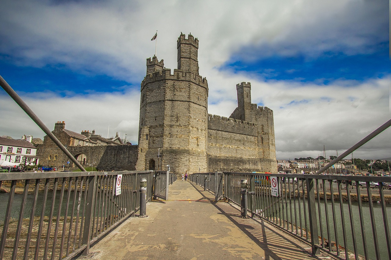 Welsh castle with green mountains and dramatic sky